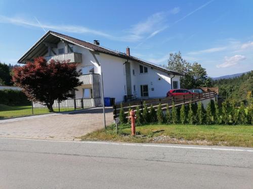 a white house with a fire hydrant in front of it at Ferienhaus Sonja in Lindberg