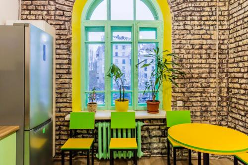 a room with a table and chairs and a window at Vorobey Hostel in Kyiv