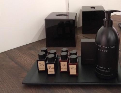a black tray with a bottle of wine and other items at Hotel 1622 - Spa, Hotell & Konferens in Helsingborg