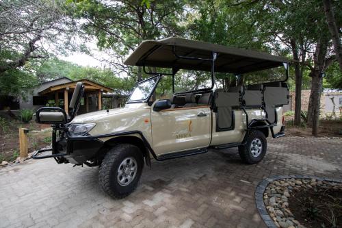a tan jeep with a cover on top of it at Little Africa Safari Lodge in Hoedspruit