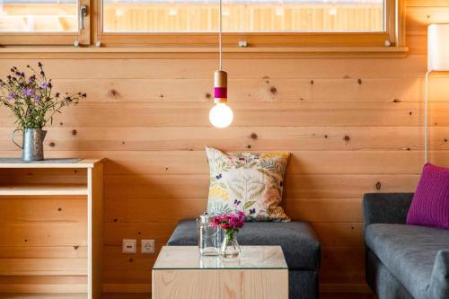 a living room with a couch and a table at Himmelreich-Chalets in Lam