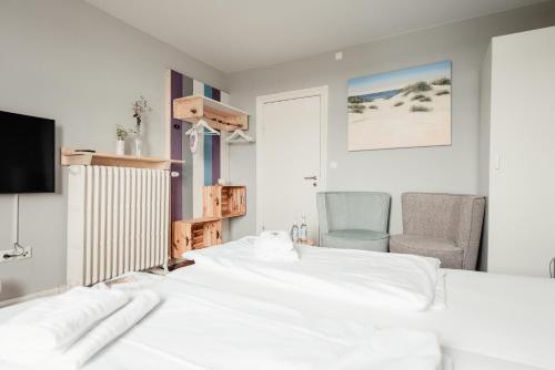 Hotel 'Das Strandhaus'にあるベッド