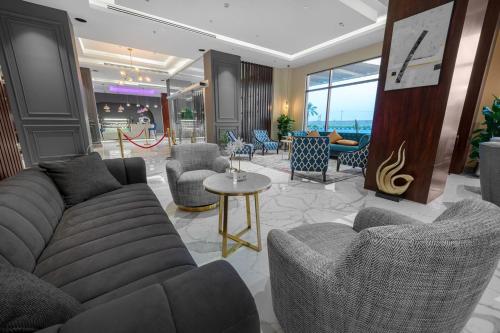 a lobby with a couch and chairs and a table at Suknai Royal Hotel in Hail