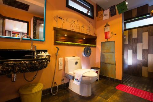 a bathroom with a toilet and a sink at Is Am O Chiang Mai Resort in San Sai