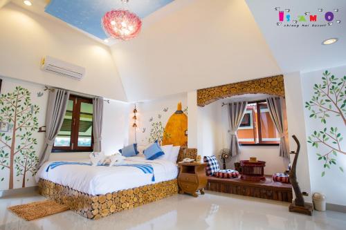 a bedroom with a bed in a room at Is Am O Chiang Mai Resort in San Sai