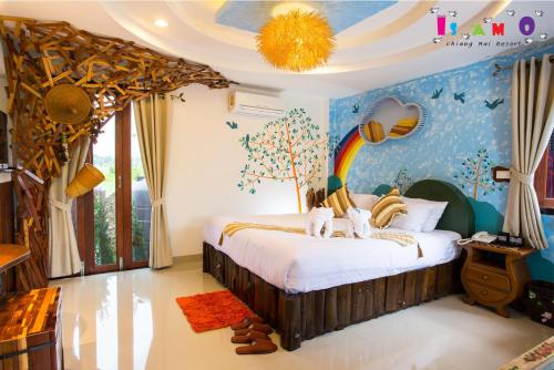 a bedroom with a bed with a tree and a rainbow at Is Am O Chiang Mai Resort in San Sai