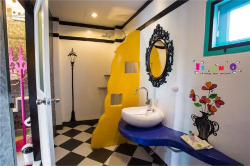 a bathroom with a sink and a mirror at Is Am O Chiang Mai Resort in San Sai