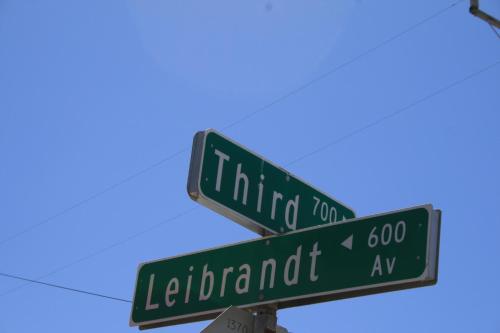 two green street signs on top of a pole at Rio Vista Inn & Suites Santa Cruz in Santa Cruz