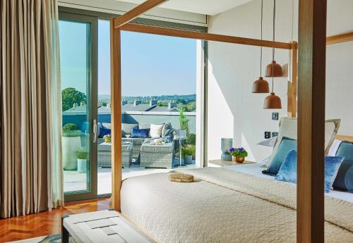 a bedroom with a bed with a view of a patio at Seafield Hotel & Spa Resort in Gorey