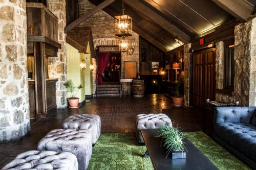 a lobby with couches and tables in a building at Old Stone Inn Boutique Hotel in Niagara Falls