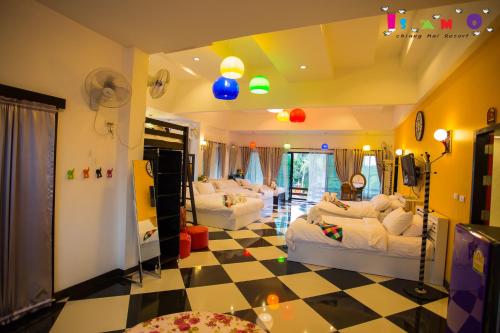 a living room with two beds and a checkered floor at Is Am O Chiang Mai Resort in San Sai
