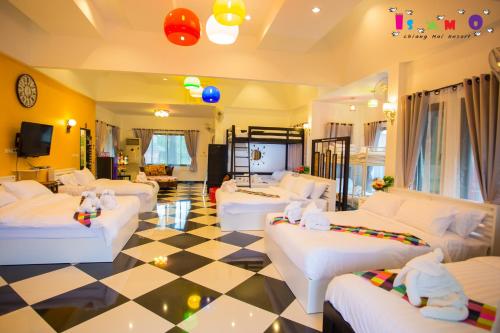 a living room with white couches and a checkered floor at Is Am O Chiang Mai Resort in San Sai