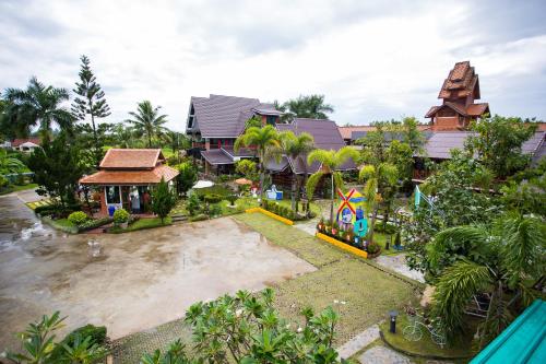 an aerial view of a house with a playground at Is Am O Chiang Mai Resort in San Sai