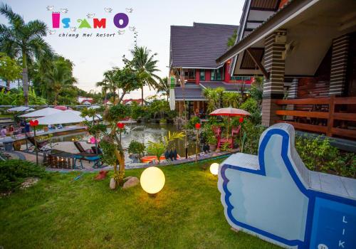 a resort yard with a slide and a pool at Is Am O Chiang Mai Resort in San Sai