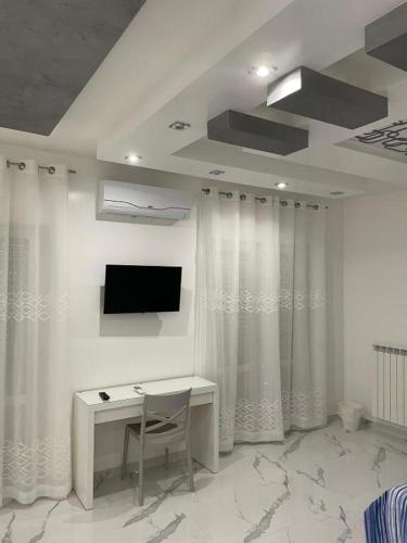 a room with a desk and a tv and curtains at B&B IL PICCOLO PRINCIPE in Mercato San Severino