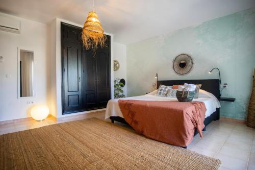a bedroom with a large bed and a lamp at Malaga Hills Double Comfort Boutique & Wellness Eco-Hotel -Adults Only- in Cómpeta