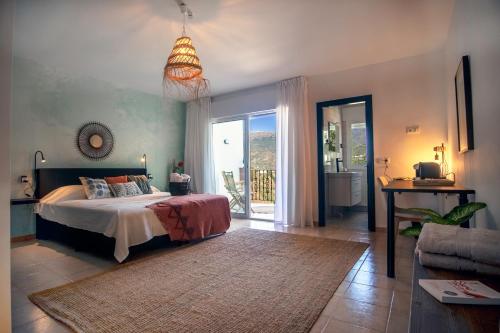 a bedroom with a bed and a view of a balcony at Malaga Hills Double Comfort Boutique & Wellness Eco-Hotel -Adults Only- in Cómpeta