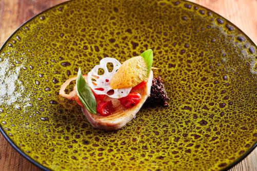 a yellow plate with a piece of food on it at Kristiania Lech in Lech am Arlberg
