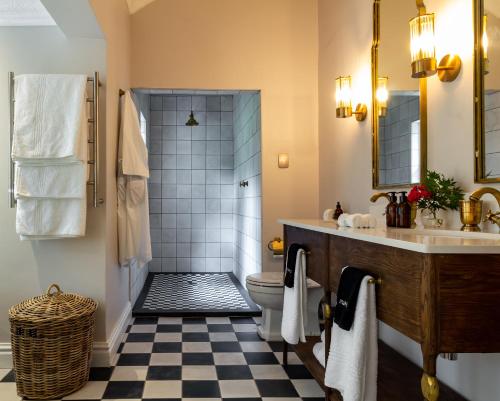 a bathroom with a shower and a toilet and a sink at Hartford House in Mooirivier