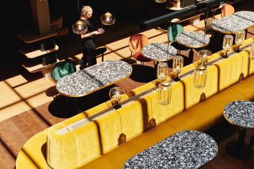 an overhead view of tables and chairs in a restaurant at Hotel Gilbert in Vienna