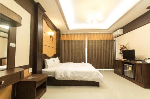 Ένα ή περισσότερα κρεβάτια σε δωμάτιο στο The Muk Lagoon