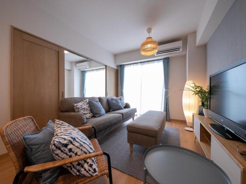 a living room with a couch and a television at Hotel Best Price Kochi in Kochi