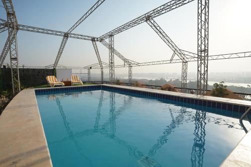 a large swimming pool on top of a building at Swiss Inn Nile Hotel in Cairo