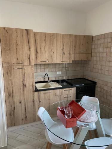 a kitchen with a table and chairs and a sink at Sweetlove Spa in Terracina