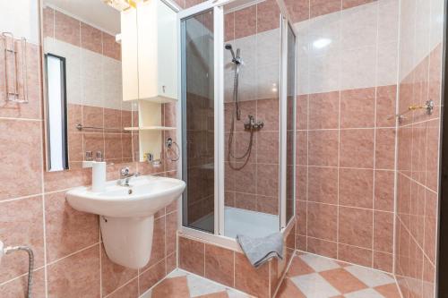 a bathroom with a sink and a shower at Penzion Na Starém náměstí in Sokolov