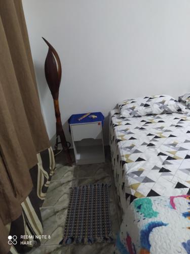 a bedroom with a bed with a quilt on it at Recanto do Luar in São Miguel do Gostoso