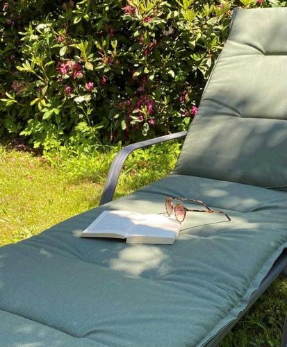 a pair of glasses and a book on a bench at Ferienwohnung miraBelle in Erbach im Odenwald