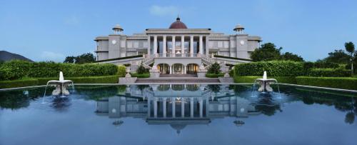 a house with a pool in front of it at Raffles Udaipur in Udaipur