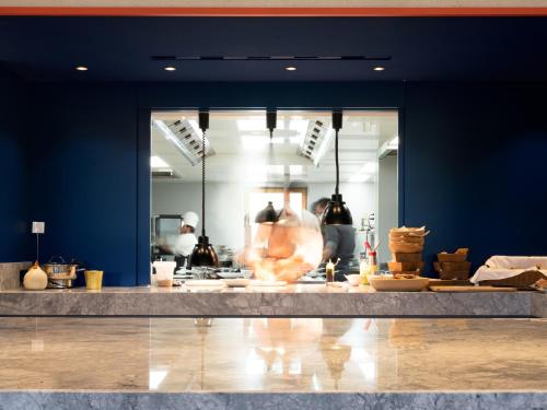 a kitchen with blue walls and a counter with food at ICARO Hotel in Alpe di Siusi