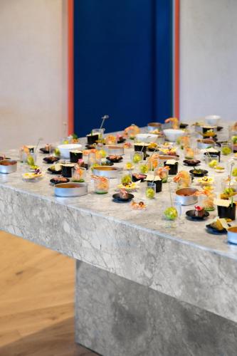 a table with many plates of food on it at ICARO Hotel in Alpe di Siusi
