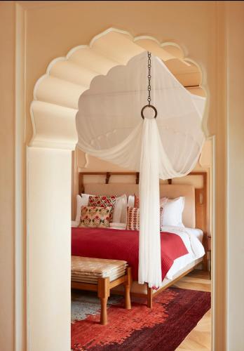 a bedroom with a bed with a canopy at Six Senses Fort Barwara Sawai Madhopur in Sawāi Mādhopur