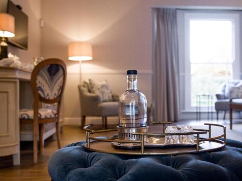 a bottle on a table in a living room at Hartford House in Mooirivier