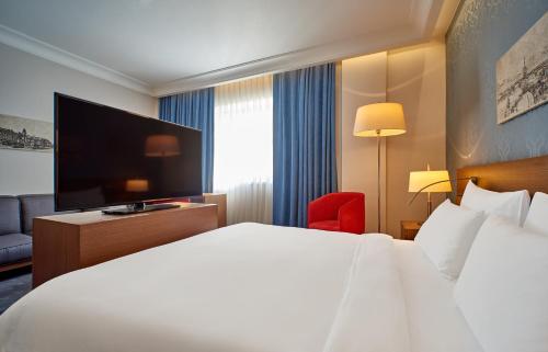 a hotel room with a bed and a television at Radisson Blu Hotel, Kyiv Podil City Centre in Kyiv