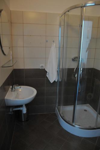 a bathroom with a shower and a sink at Vinci in Krakow