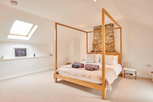 a bedroom with a bed with a large mirror at Wildhaven- Idylic rural farmhouse with log burner and countryside views in Gwynfe