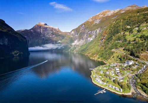 an aerial view of a lake in the mountains at Geirangerfjorden Feriesenter in Geiranger