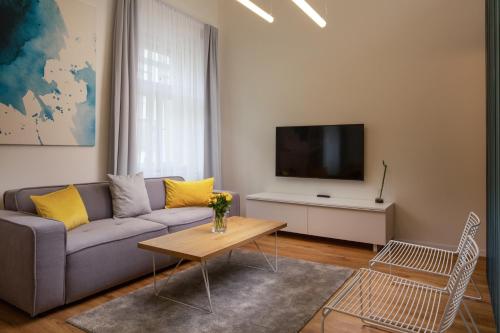 a living room with a couch and a tv at OREA Place Seno in Prague