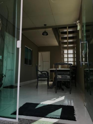 a living room with a table and chairs and a staircase at Apartamento Marquinho in Urubici