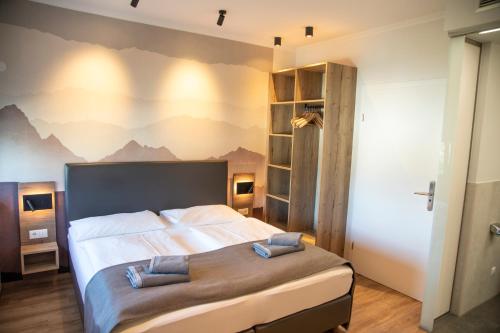 een slaapkamer met een bed met een muurschildering van de bergen bij Hotel Restaurant Auerhahn in Salzburg