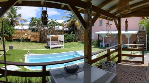 a view from the deck of a house with a pool at Villa Rosa Karibella in Saint-François