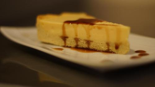 a piece of cheesecake on a plate on a table at Casa Cavoquinho in Paul