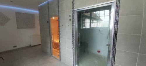 a shower with a glass door in a bathroom at Dalgarven spa venue in Kilwinning