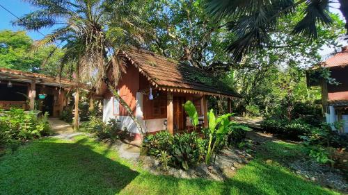 a small house in the middle of a yard at Chalet Y Cabinas Hibiscus in Cahuita