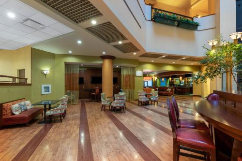 a lobby of a hospital with tables and chairs at Wyndham Grand Oklahoma City Downtown in Oklahoma City