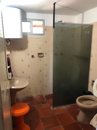 a bathroom with a shower and a toilet and a sink at Pancho Villa in Barra de Valizas
