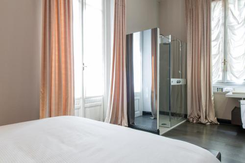 a bedroom with a mirror and a bed and a window at Milan Royal Suites - Centro in Milan